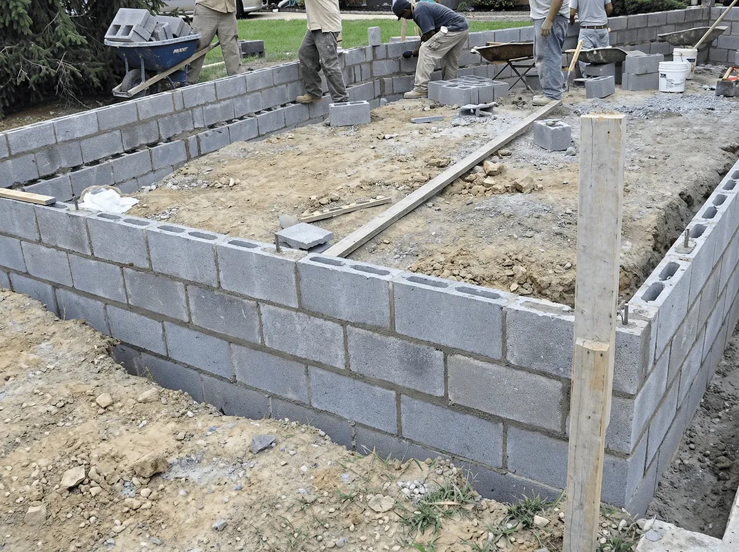 Professionals building a foundation with blocks in Columbia, MO